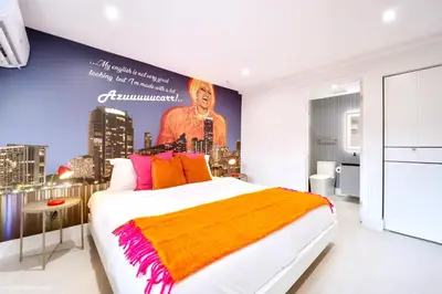 a bedroom with a large bed with a poster on the wall at The Rock & Rhythm Villa Miami Downtown - Playground,Mini Golf, BBQ, Garden Relaxation in Miami