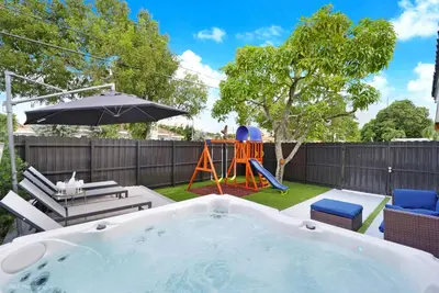 a backyard with a hot tub and a playground at The Rock & Rhythm Villa Miami Downtown - Playground,Mini Golf, BBQ, Garden Relaxation in Miami