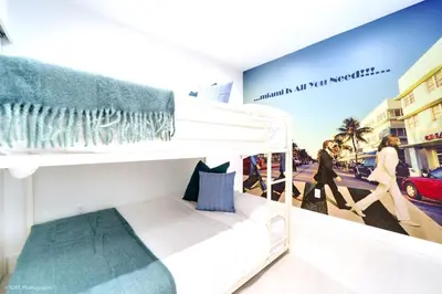 a white bunk bed in a room with a poster at The Rock & Rhythm Villa Miami Downtown - Playground,Mini Golf, BBQ, Garden Relaxation in Miami