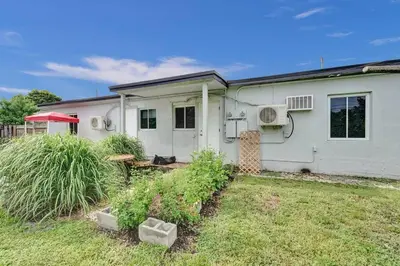 a white house with plants in front of it at Explorer's Retreat Villa in Miami