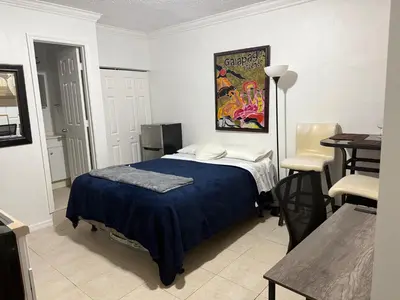 a bedroom with a bed and a table in it at My Garden in Miami Florida in Palmetto Bay