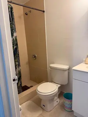 a bathroom with a toilet and a shower at My Garden in Miami Florida in Palmetto Bay
