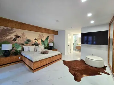 a bedroom with a large bed and a tv at Sunset Retreat at Heart of Miami with pool in Miami