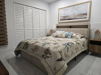 a bedroom with a bed with a blanket and pillows at Sunset Retreat at Heart of Miami with pool in Miami