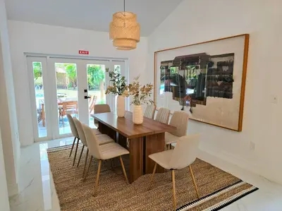 a dining room with a wooden table and chairs at Sunset Retreat at Heart of Miami with pool in Miami