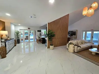 a large living room with a couch and a table at Sunset Retreat at Heart of Miami with pool in Miami