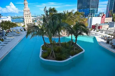 a large swimming pool with palm trees on top of a city at Magic Miami Penthouse Balcony, Insane Ocean & City Views Luxury,Pool,Spa,Gym in Miami