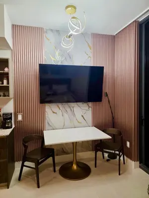 a table with two chairs and a tv on a wall at Magic Miami Penthouse Balcony, Insane Ocean & City Views Luxury,Pool,Spa,Gym in Miami