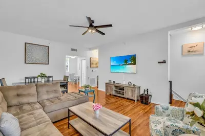 a living room with a couch and a ceiling fan at Fantastic Townhouse Beach Access Resort Amenities! in Hallandale Beach