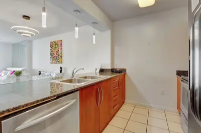 a kitchen with a sink and a refrigerator at Bay View Condo, Sleeps 6, Pool, Spa, Gym and Games in Miami