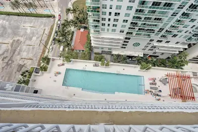 an overhead view of a swimming pool with buildings at Bay View Condo, Sleeps 6, Pool, Spa, Gym and Games in Miami