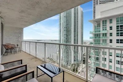 a balcony with a view of a building at Bay View Condo, Sleeps 6, Pool, Spa, Gym and Games in Miami