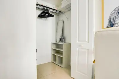 a room with a white door and a shelf at Modern Studio with Balcony, Pool, Gym and Games in Miami