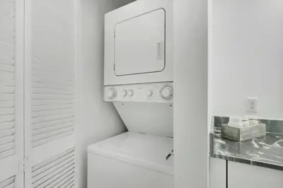 a white laundry room with a washer and dryer at Fall in love with Brickell - Your Miami home in Miami