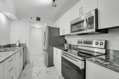 a kitchen with a stove and a microwave at Fall in love with Brickell - Your Miami home in Miami
