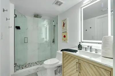 a bathroom with a shower and a toilet and a sink at Fall in love with Brickell - Your Miami home in Miami