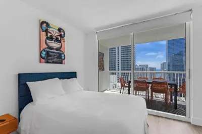 a bedroom with a large bed and a balcony at Curated Sky Abode Ocean and City views, Sleeps 6 in Miami