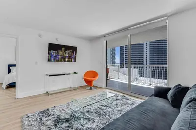 a living room with a couch and a large window at Curated Sky Abode Ocean and City views, Sleeps 6 in Miami