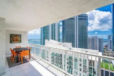 a balcony with a table and chairs and a view of the city at Curated Sky Abode Ocean and City views, Sleeps 6 in Miami