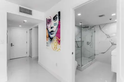 a bathroom with a shower and a painting on the wall at Magnificent Ocean Sky Residence in Miami