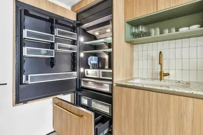 a kitchen with an open refrigerator and a sink at Sky-High Views Pool and Fitness Center Access in Miami