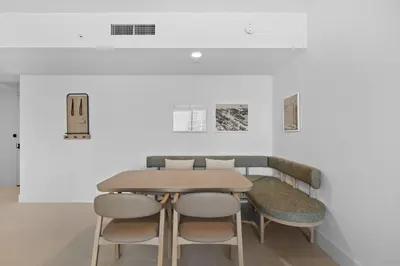 a table and chairs in a room with white walls at Luxury 45th-Floor Condo with Stunning City Views in Miami
