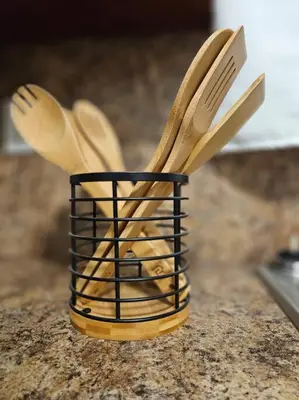 a container filled with wooden utensils sitting on a counter at Wynwood Miami Family Oasis in Miami
