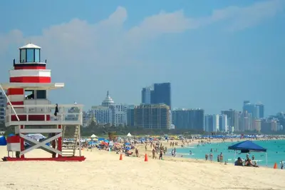 a beach with a lifeguard tower and a crowd of people at Wynwood Miami Family Oasis in Miami