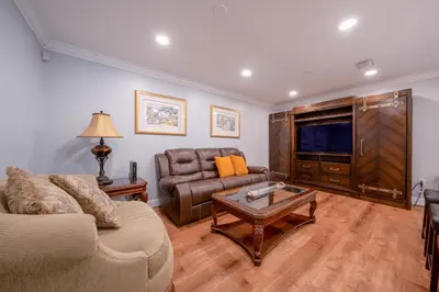 a living room with a couch and a television at House Genesis in Homestead
