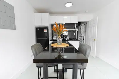 a kitchen with a dining room table with chairs at Central King Studio Quiet & Close to Hard Rock in Miami Gardens