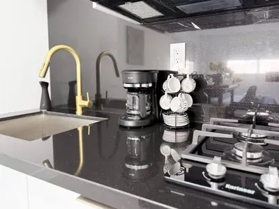 a kitchen counter with a coffee maker on a stove at Central King Studio Quiet & Close to Hard Rock in Miami Gardens