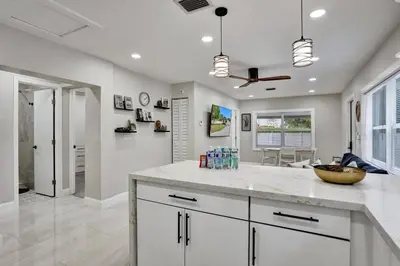 a kitchen with a white counter top and a living room at Hollywood Lux Retreat in Hollywood