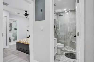 a white bathroom with a shower and a toilet at Hollywood Lux Retreat in Hollywood