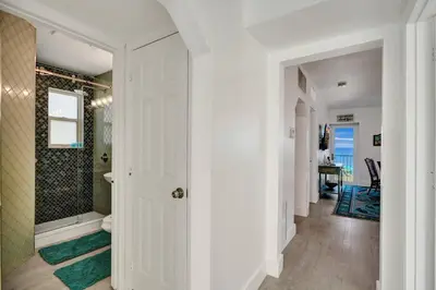 a bathroom with a walk in shower next to a toilet at Sunset Oceanfront Villa in Hollywood