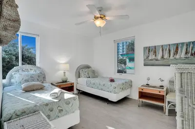 a bedroom with two beds and a ceiling fan at Sunset Oceanfront Villa in Hollywood