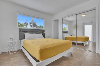 a bedroom with two beds and a large mirror at Coastal Breeze Retreat in Pembroke Pines