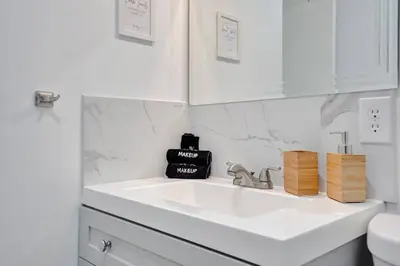 a white bathroom with a sink and a toilet at Coastal Breeze Retreat in Pembroke Pines