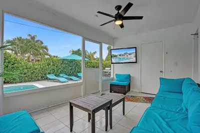 a living room with a couch and a ceiling fan at Coastal Breeze Retreat in Pembroke Pines