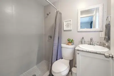 a bathroom with a toilet and a sink and a shower at Spacious East Miami Duplex Delightful in Miami