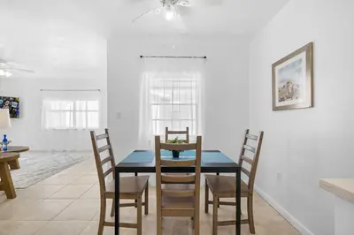 a dining room with a blue table and chairs at Sunset Inn - Hallandale Beach in Hallandale Beach