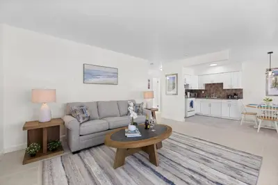 a living room with a couch and a table at Sunset Inn - Hallandale Beach in Hallandale Beach