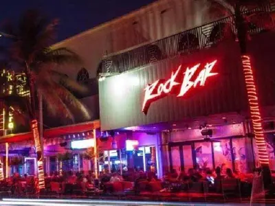 a hot bar with neon signs on the side of a building at Beachside Parking - Las Olas, Airport, Port Evg in Fort Lauderdale