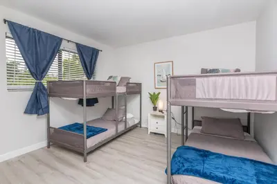 a room with two bunk beds in it at Beachside Parking - Las Olas, Airport, Port Evg in Fort Lauderdale