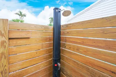 a wooden fence with a black pole at Casa Olympus Fort Lauderdale - Walk to the Beach! in Fort Lauderdale
