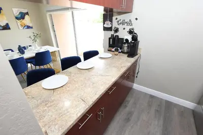 a kitchen with a counter with white plates on it at Walk to Stadium - 3BR King Bed Haven - Parking in Miami Gardens