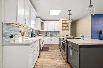 a kitchen with white cabinets and white counter tops at 3-Bedroom Villa with Heated Pool and Tropical Yard in Hollywood Lakes in Hollywood