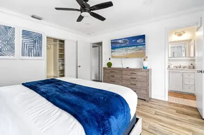 a white bedroom with a blue blanket on a bed at 3-Bedroom Villa with Heated Pool and Tropical Yard in Hollywood Lakes in Hollywood