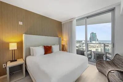 a bedroom with a white bed and a large window at On the Beach, Ocean and City Views 17 Zen at LYFE Resort in Hollywood