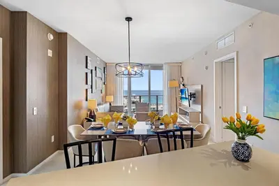 a dining room and living room with a table and chairs at On the Beach, Ocean and City Views 17 Zen at LYFE Resort in Hollywood