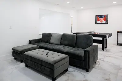 a living room with a couch and a piano at Plumeria Housing in Fort Lauderdale